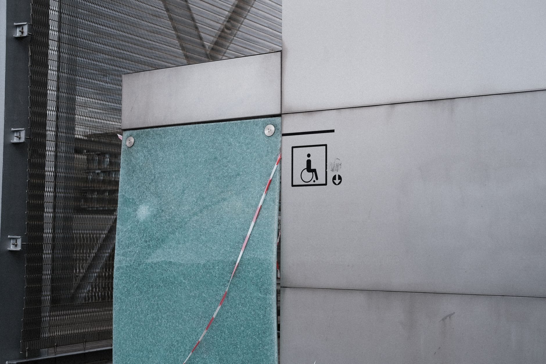 Accessible concrete ramp with handrails at a building entrance