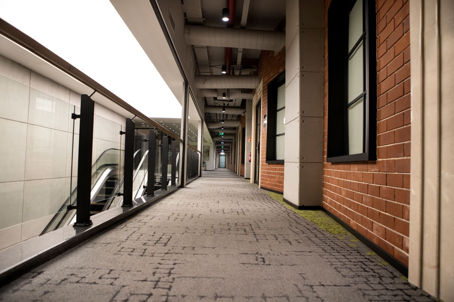 Commercial building corridor with continuous handrails along an accessible interior route