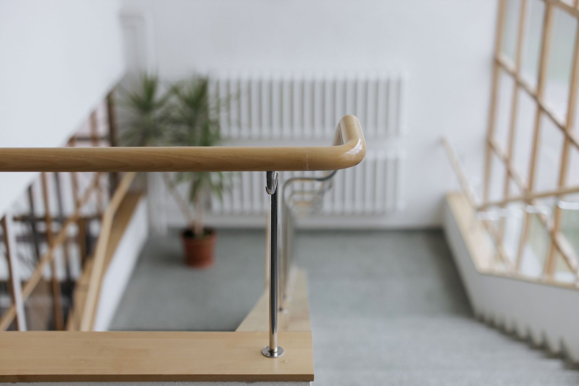 Wooden handrail on a staircase inside a modern commercial building