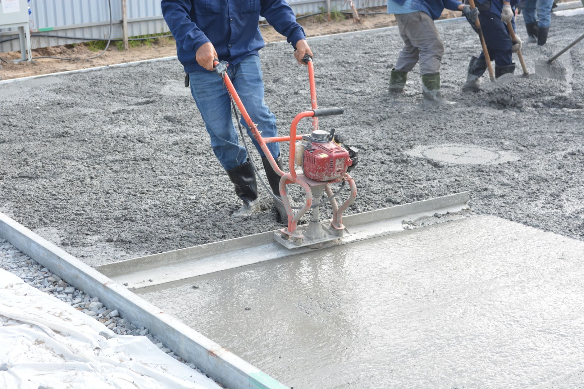 Finishing a freshly poured concrete driveway