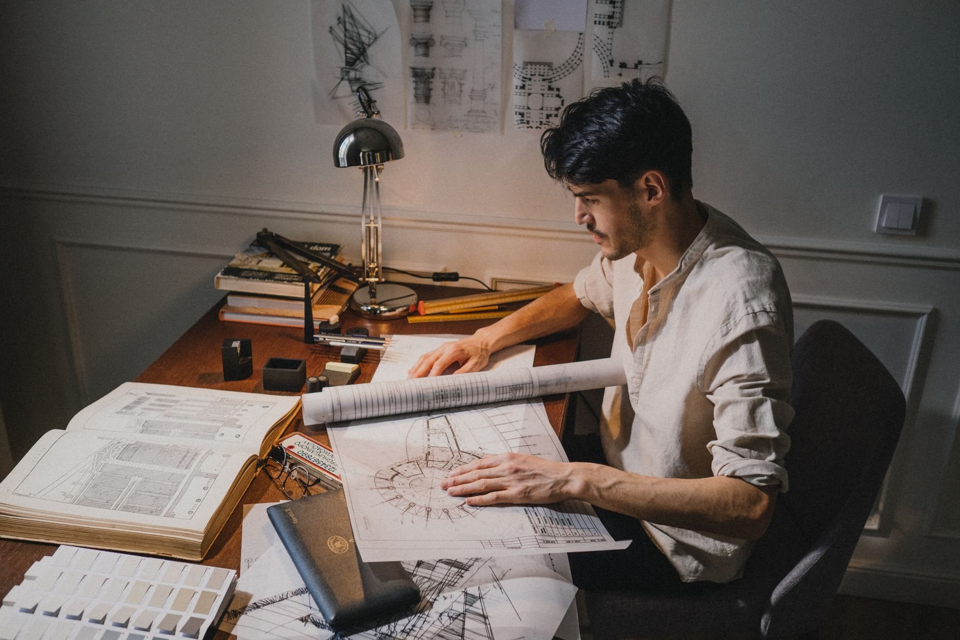 Construction drawings and scope documents spread on a work table