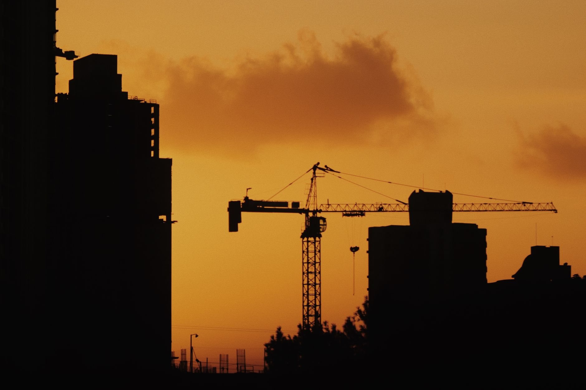 Wide view of an active construction site at first light