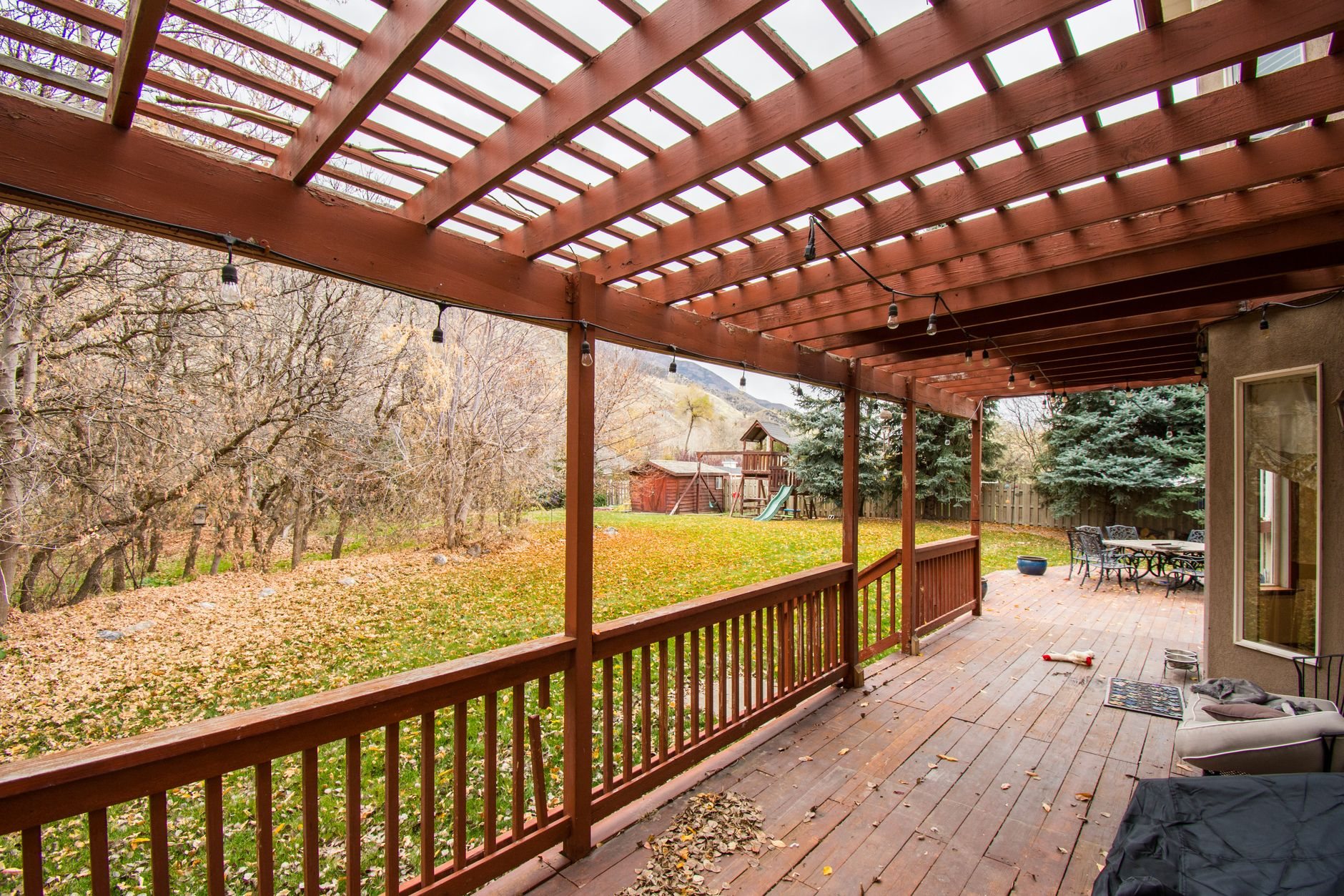 Wooden deck on a bench-lot home with mountain views in autumn