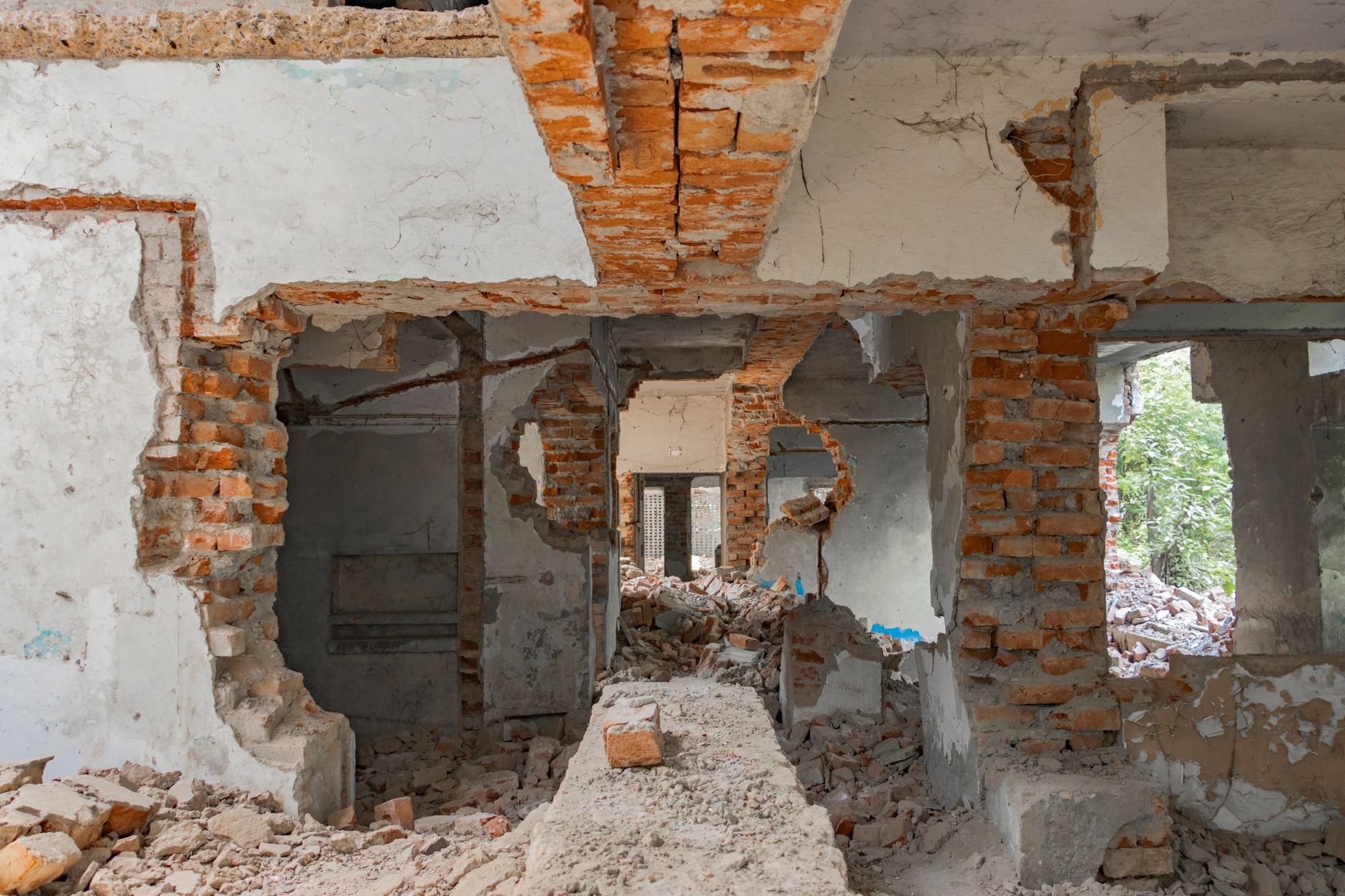Commercial building mid-demolition with exposed brick and stripped structure