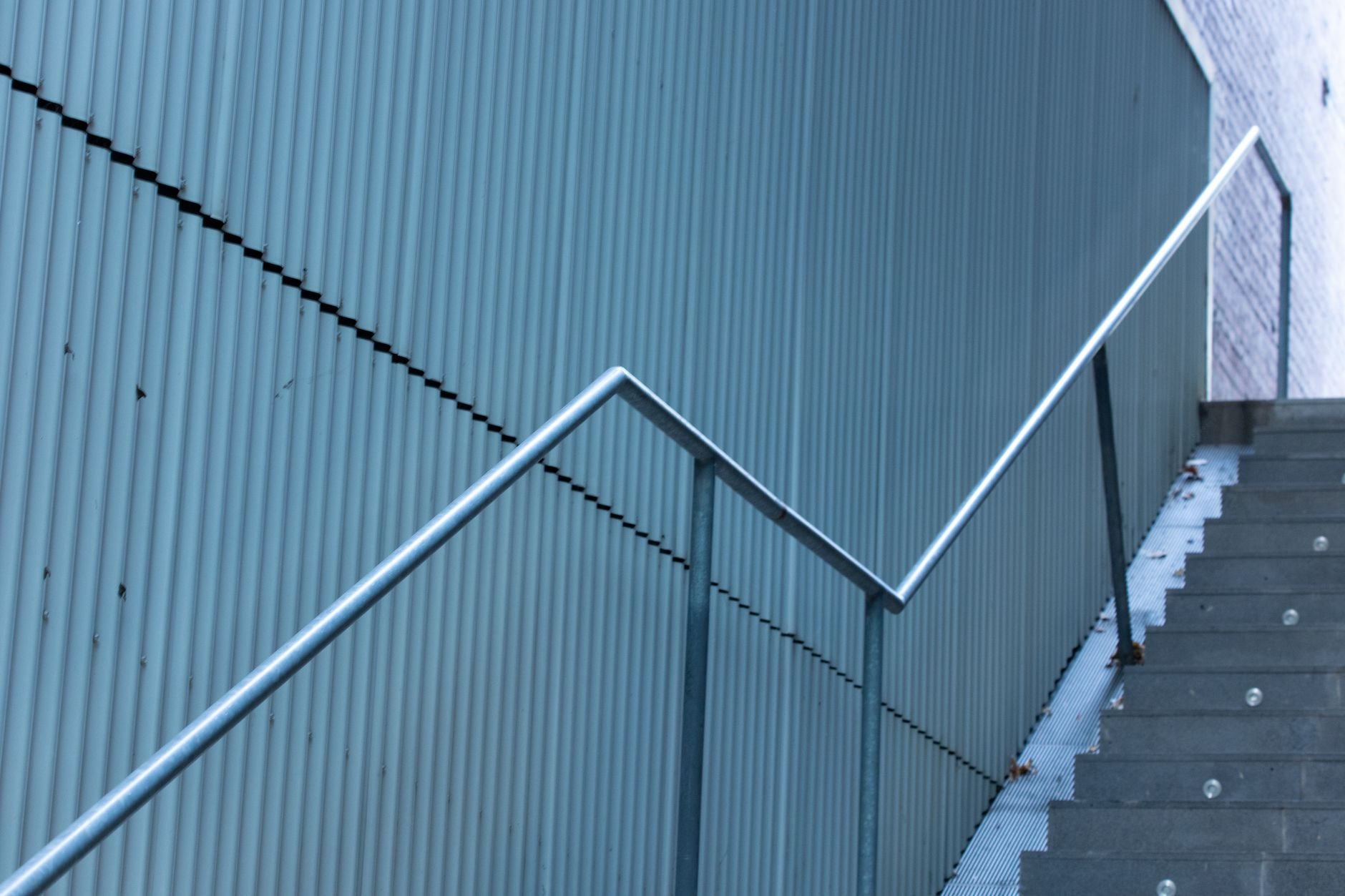 Fabricated steel staircase installed with welded stringers and metal railings