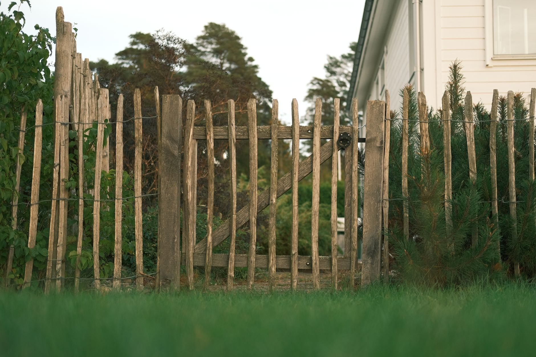 Wood rail fence enclosing a countryside yard, the kind of perimeter fencing built for Utah acreage