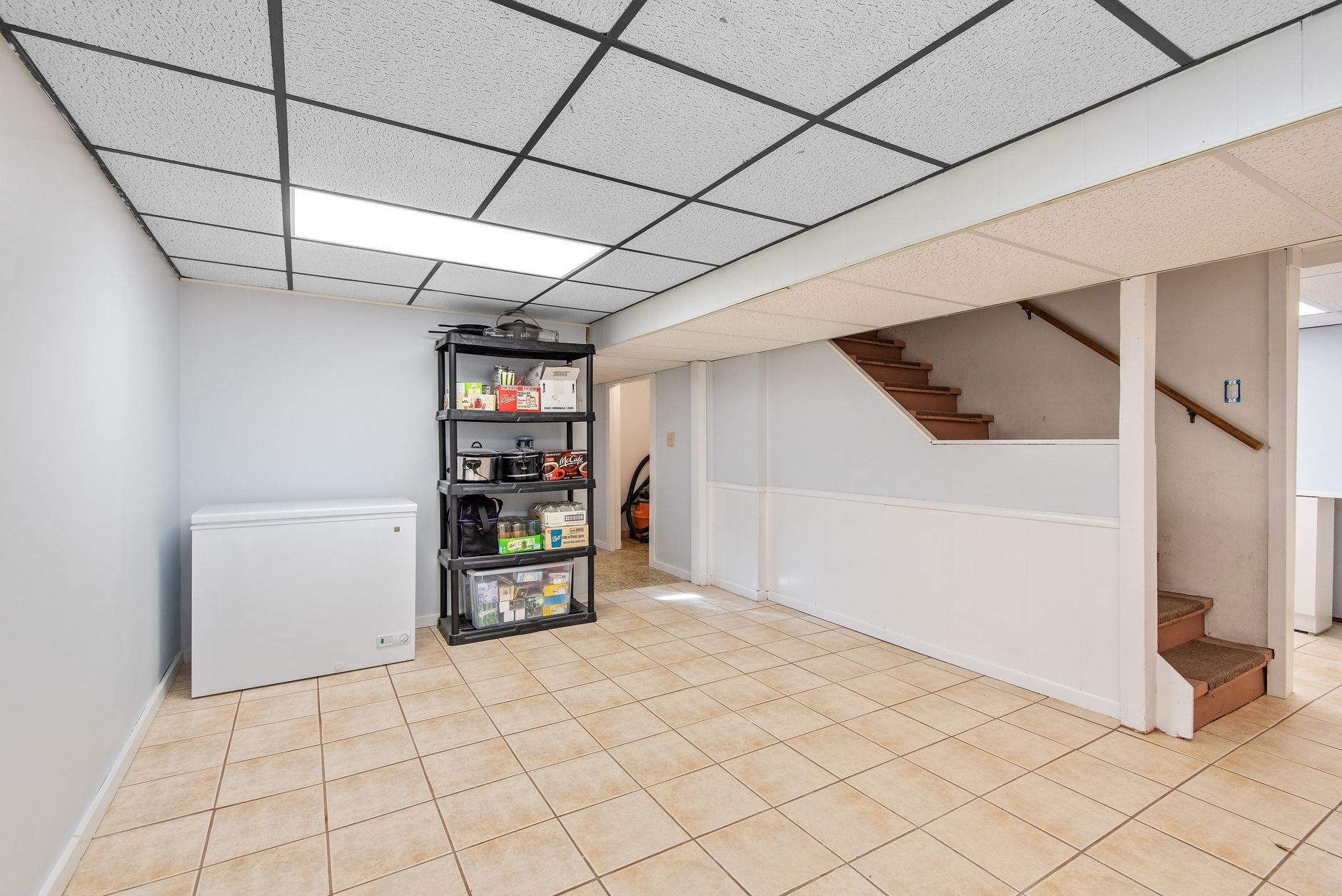 Finished basement with tile flooring and staircase, the most common project request in Lehi's post-2005 housing stock