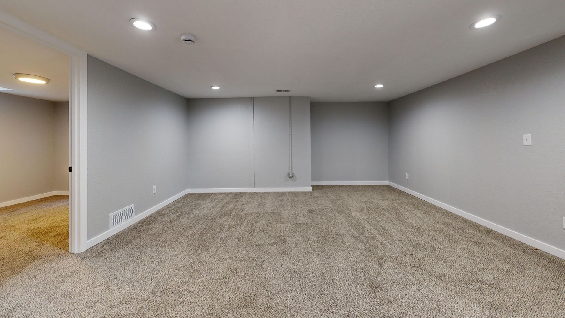 Finished basement converted to comfortable living space with modern finishes
