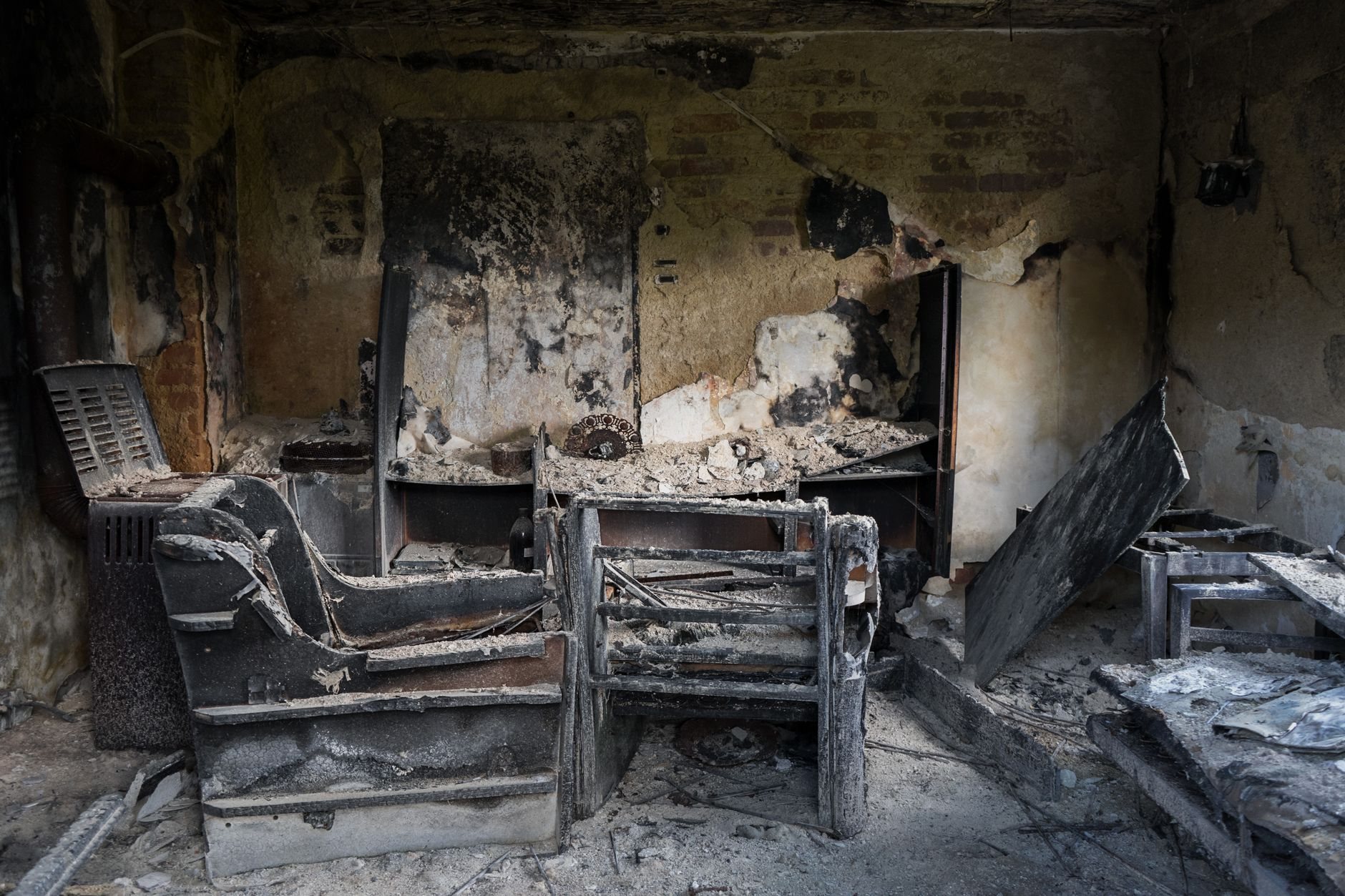 Charred interior of a fire-damaged building before the repair-versus-rebuild assessment