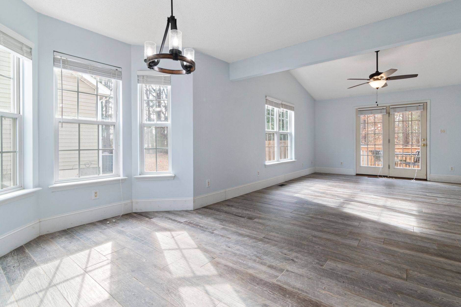 Bright living room with newly installed wood flooring in a Utah home