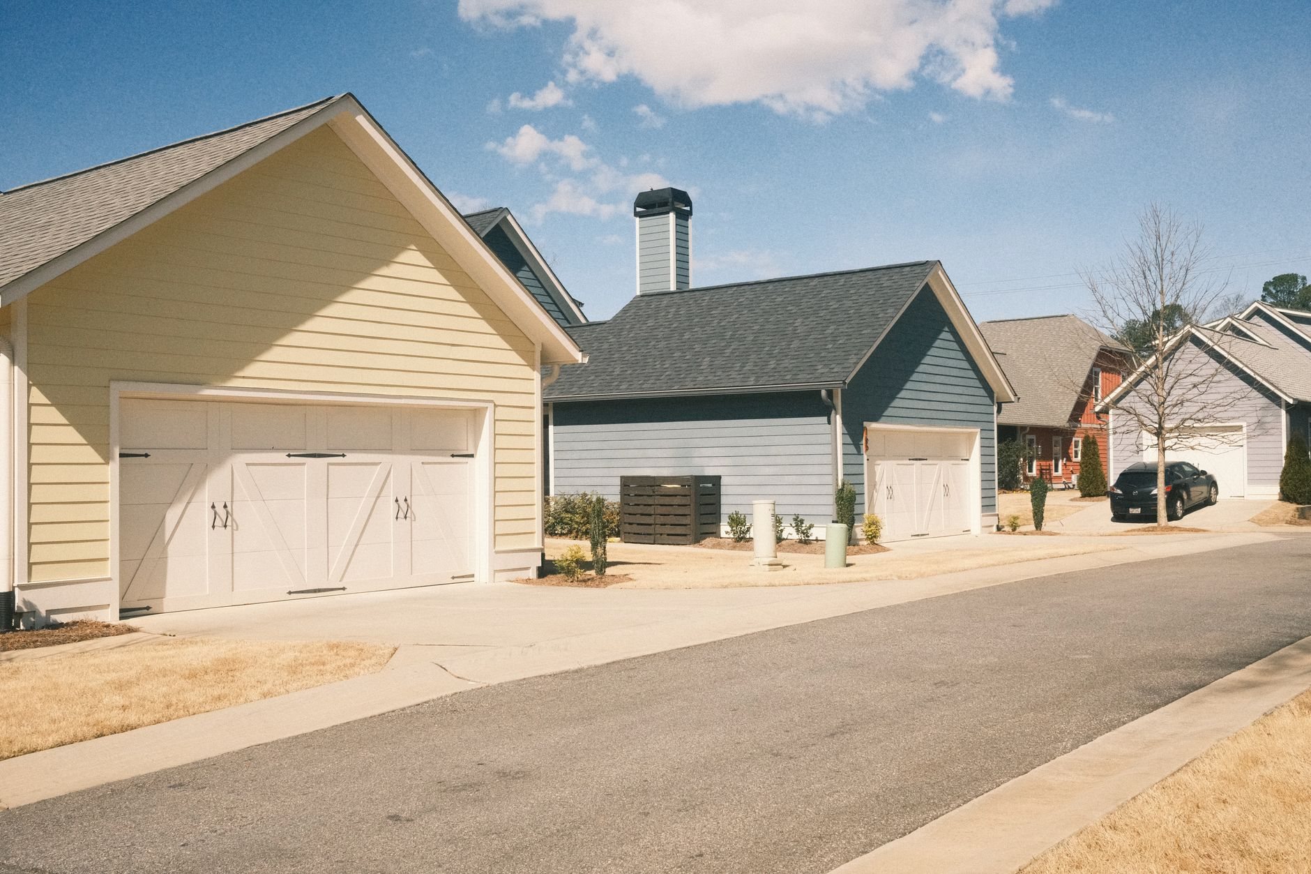 Suburban street of single-family homes with two-car garages, typical of West Jordan subdivisions