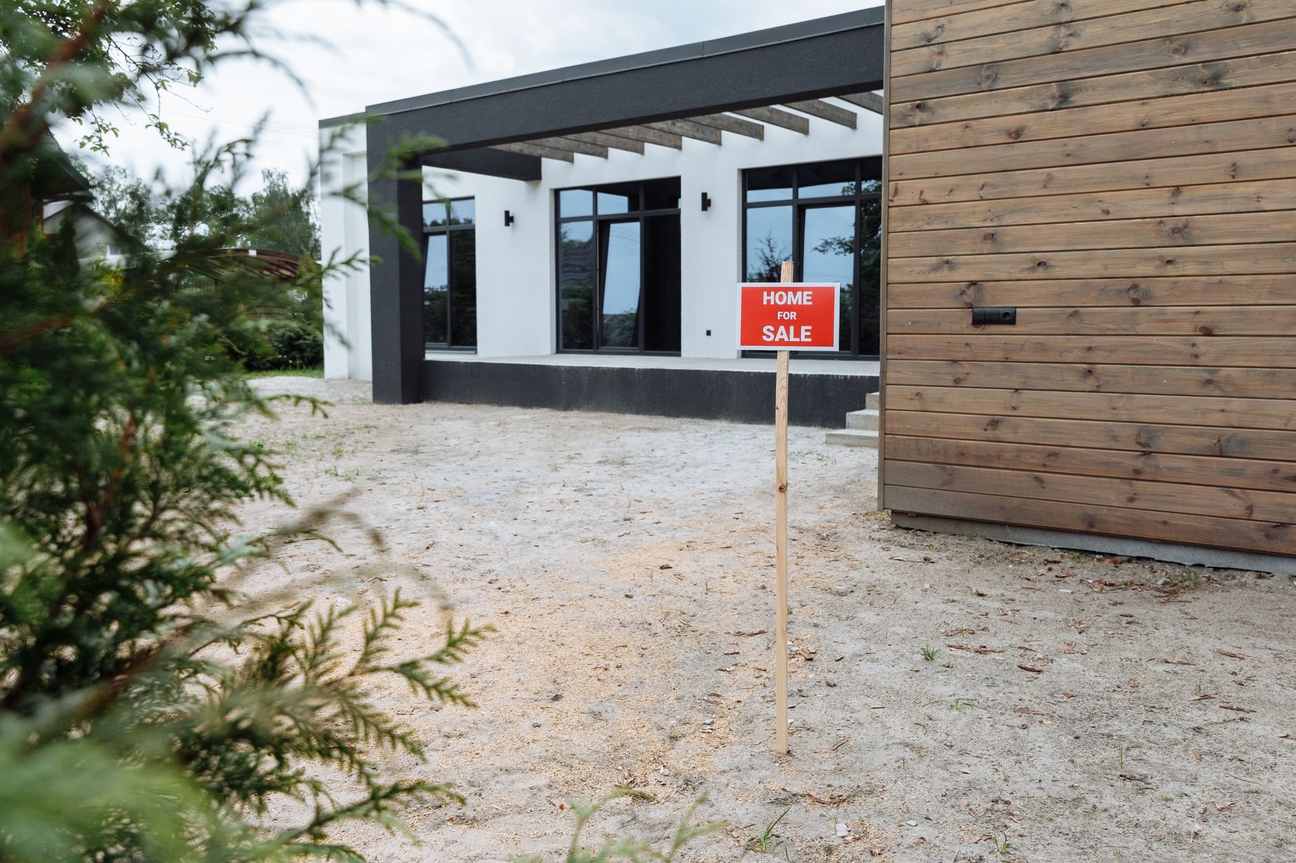 Completed spec home with a for-sale sign in the front yard