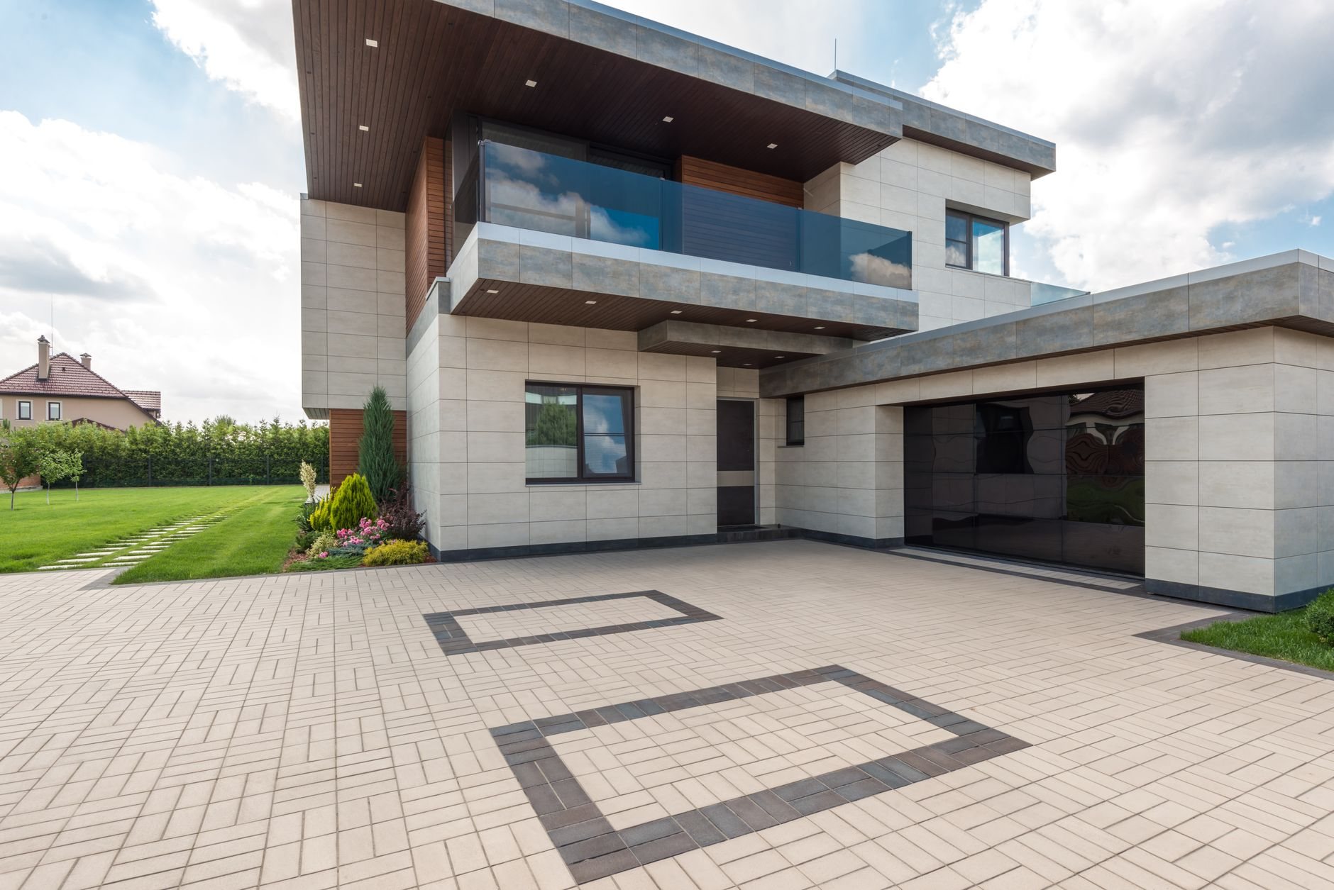 Modern home exterior with a clean stucco-style finish and geometric lines