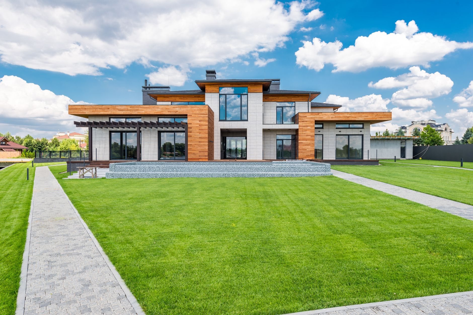 Contemporary Utah home exterior with glass patio doors and panoramic windows on a sunny day