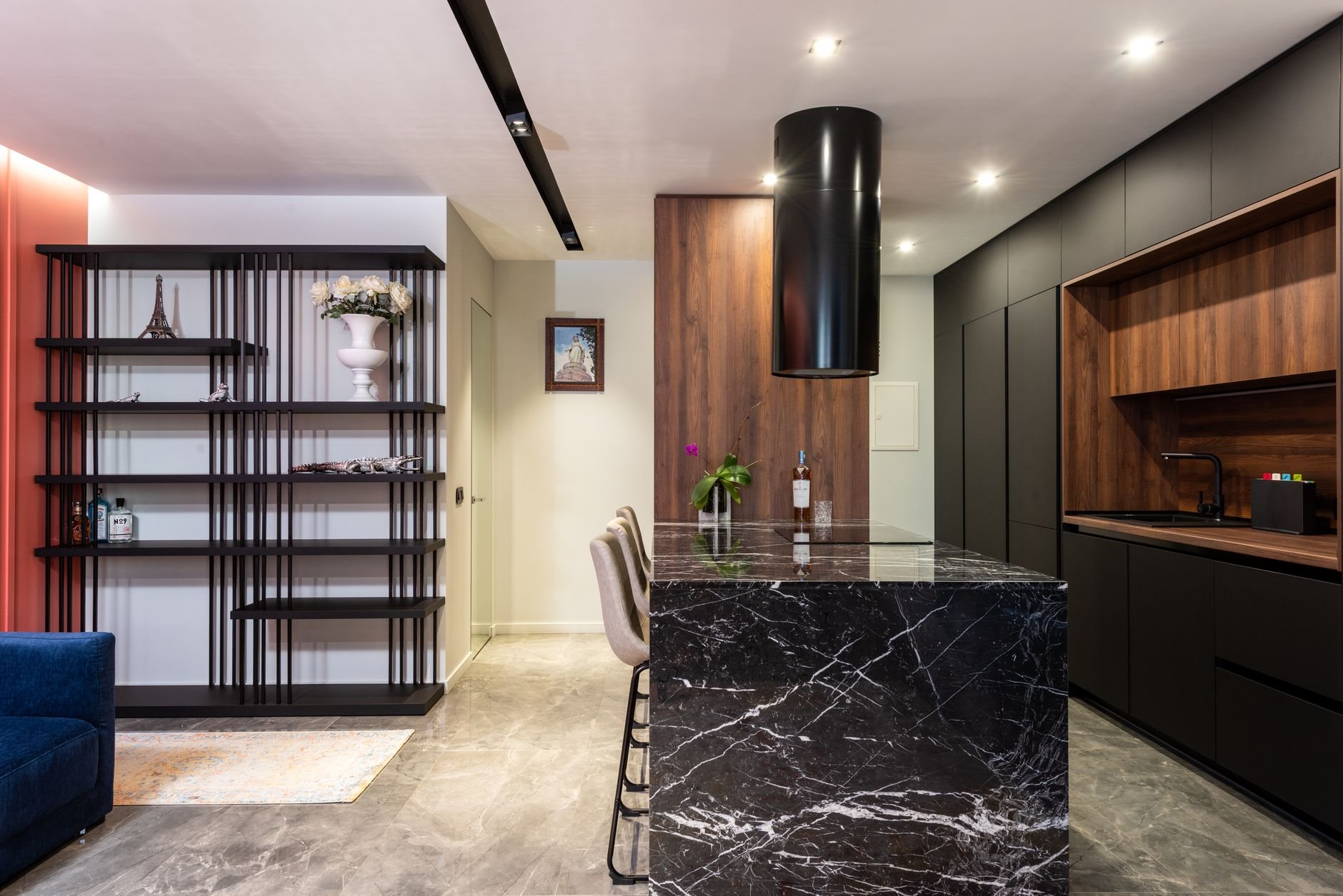 Remodeled kitchen with black marble island and wood cabinets in an updated 1980s-era home