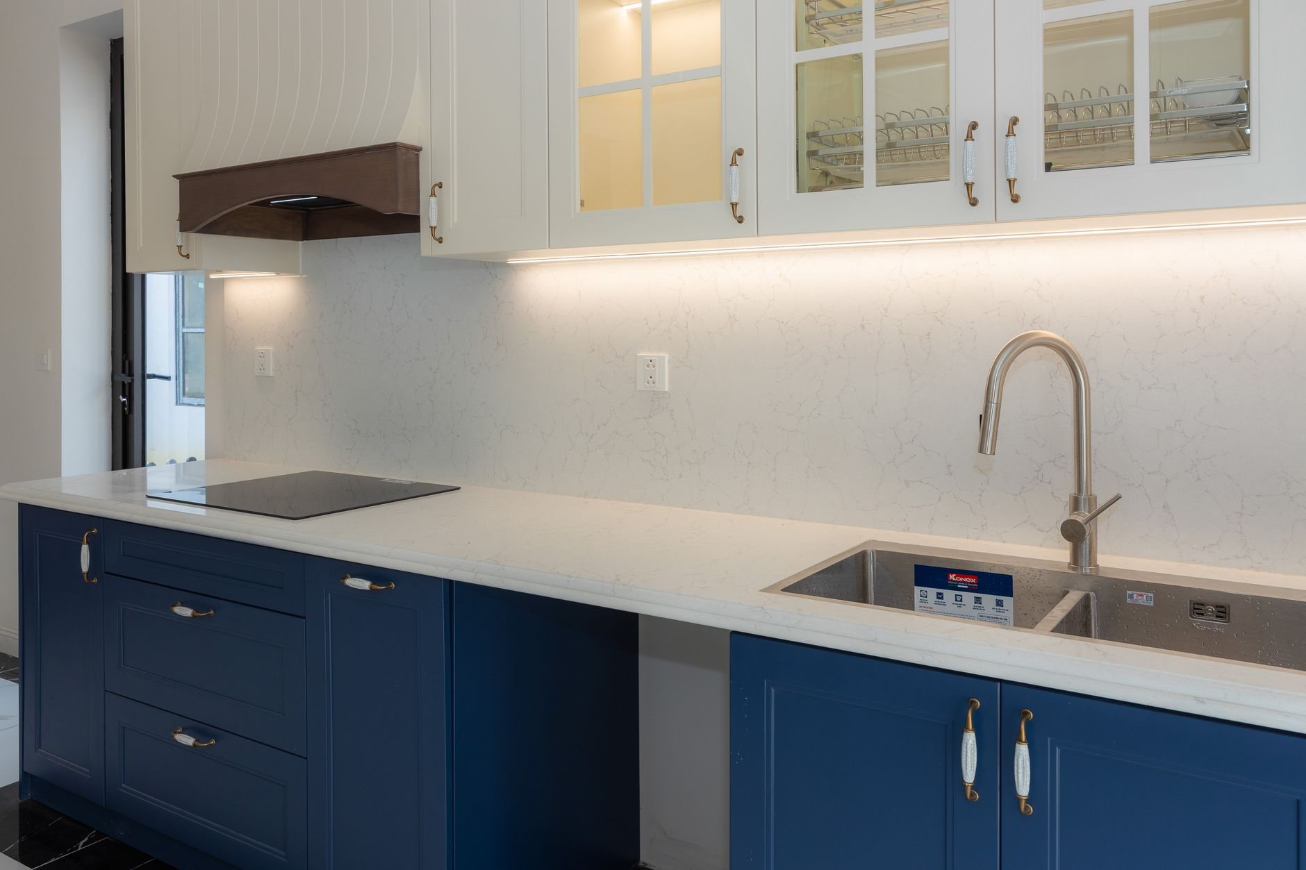 Remodeled kitchen with blue cabinets and white countertops in a mid-century Murray home