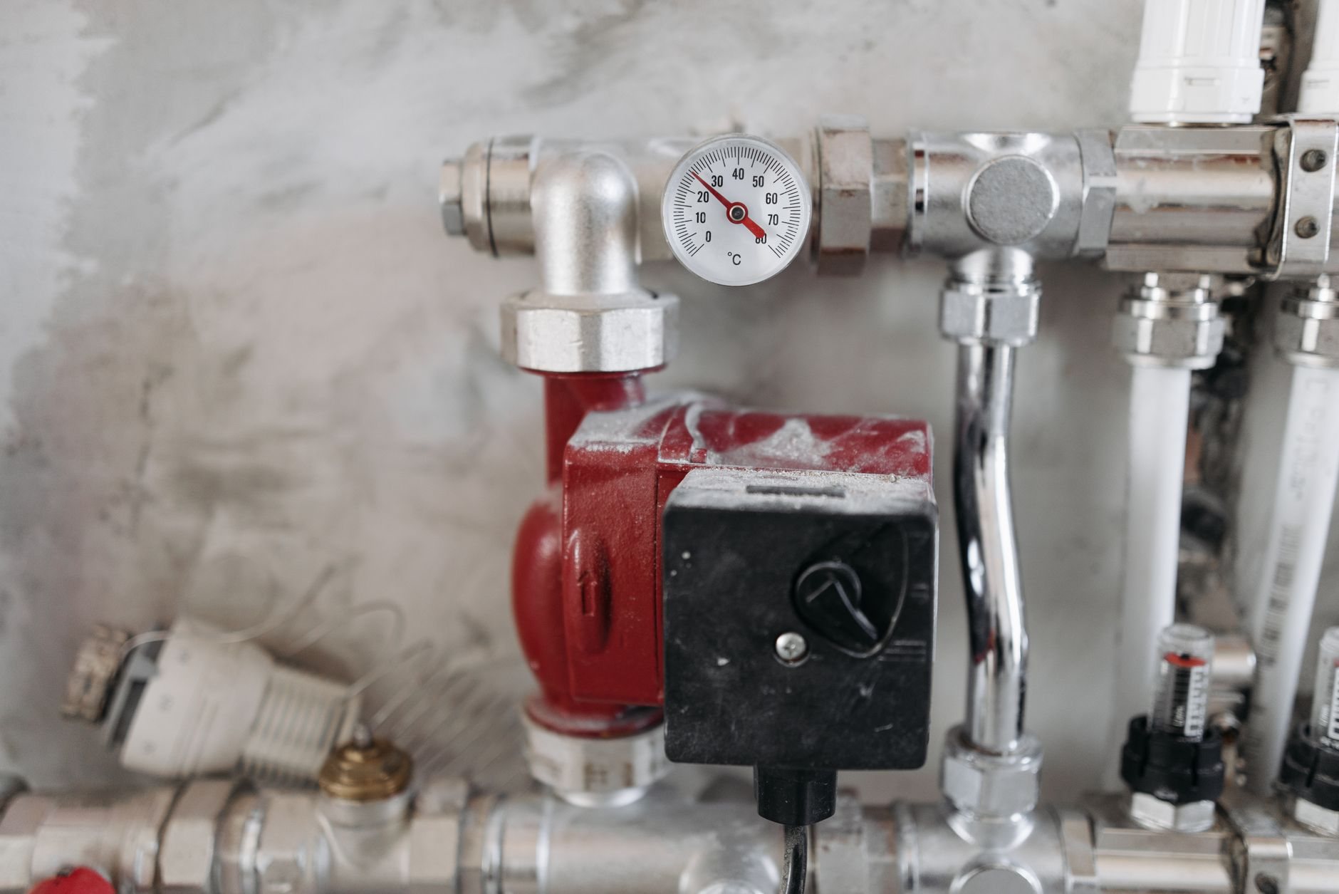 Pressure gauge and steel supply piping on a commercial plumbing system