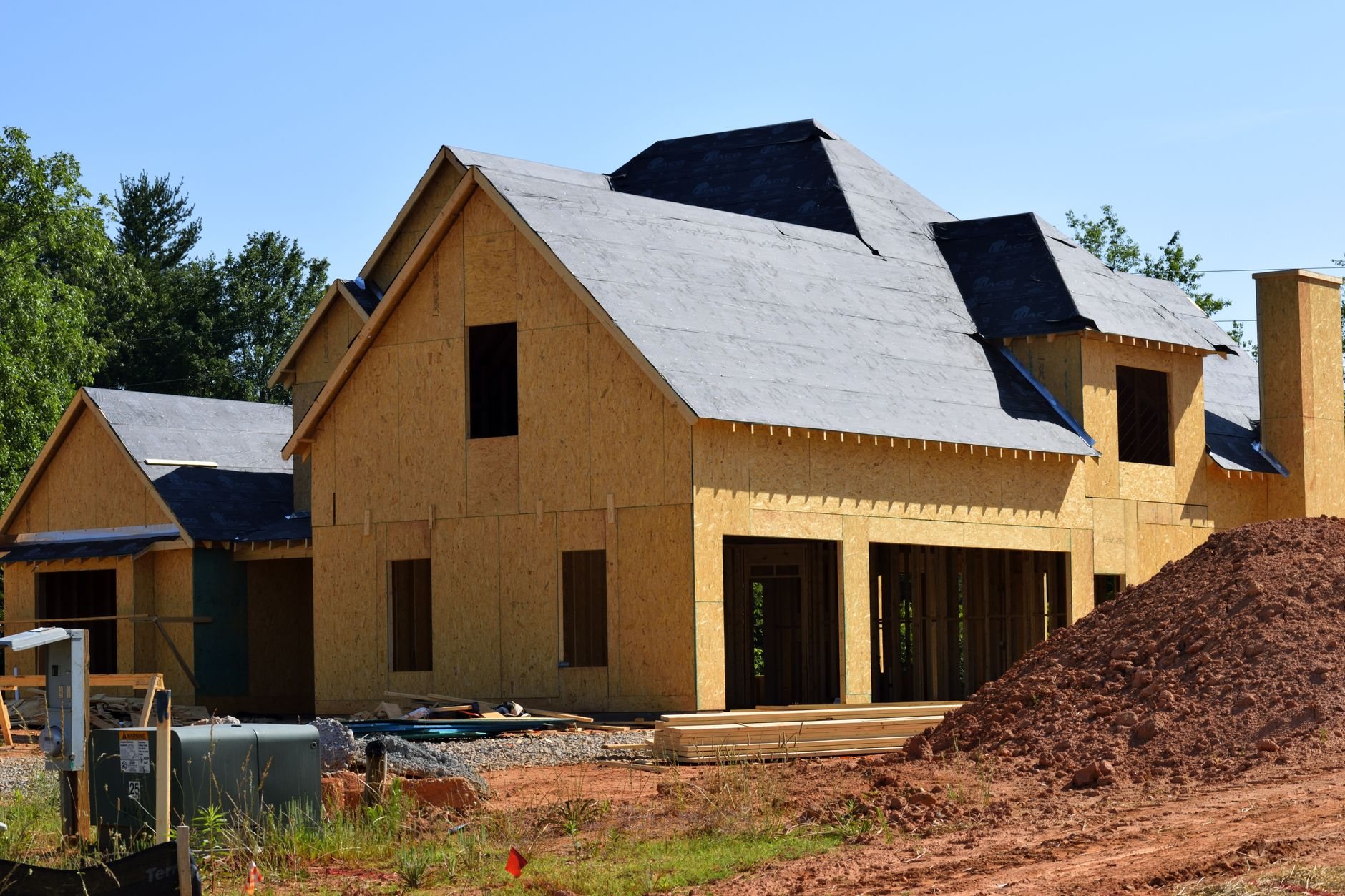 New single-family home under construction with fresh framing