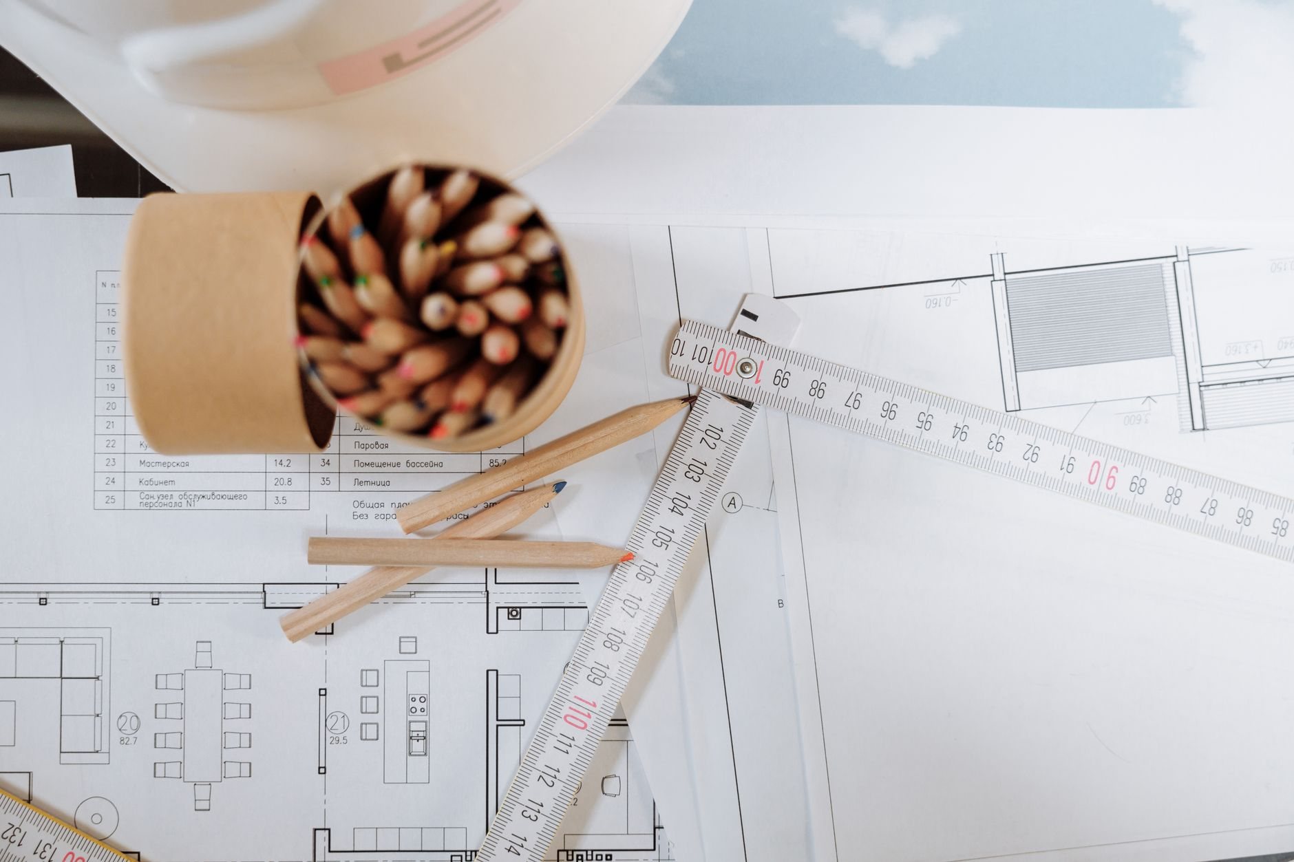 Blueprints with pencils and ruler laid out during a permit submittal pre-review