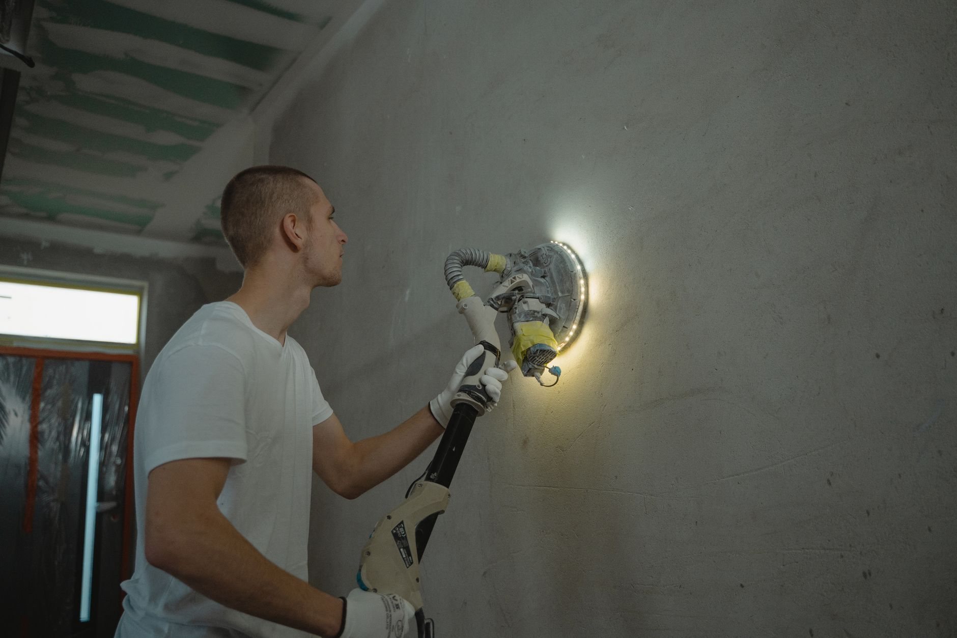 Contractor repairing and patching interior drywall