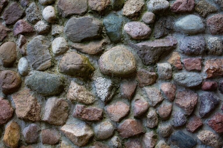Retaining and landscape work: close-up of a textured stone wall with colorful rocks in various shapes and sizes