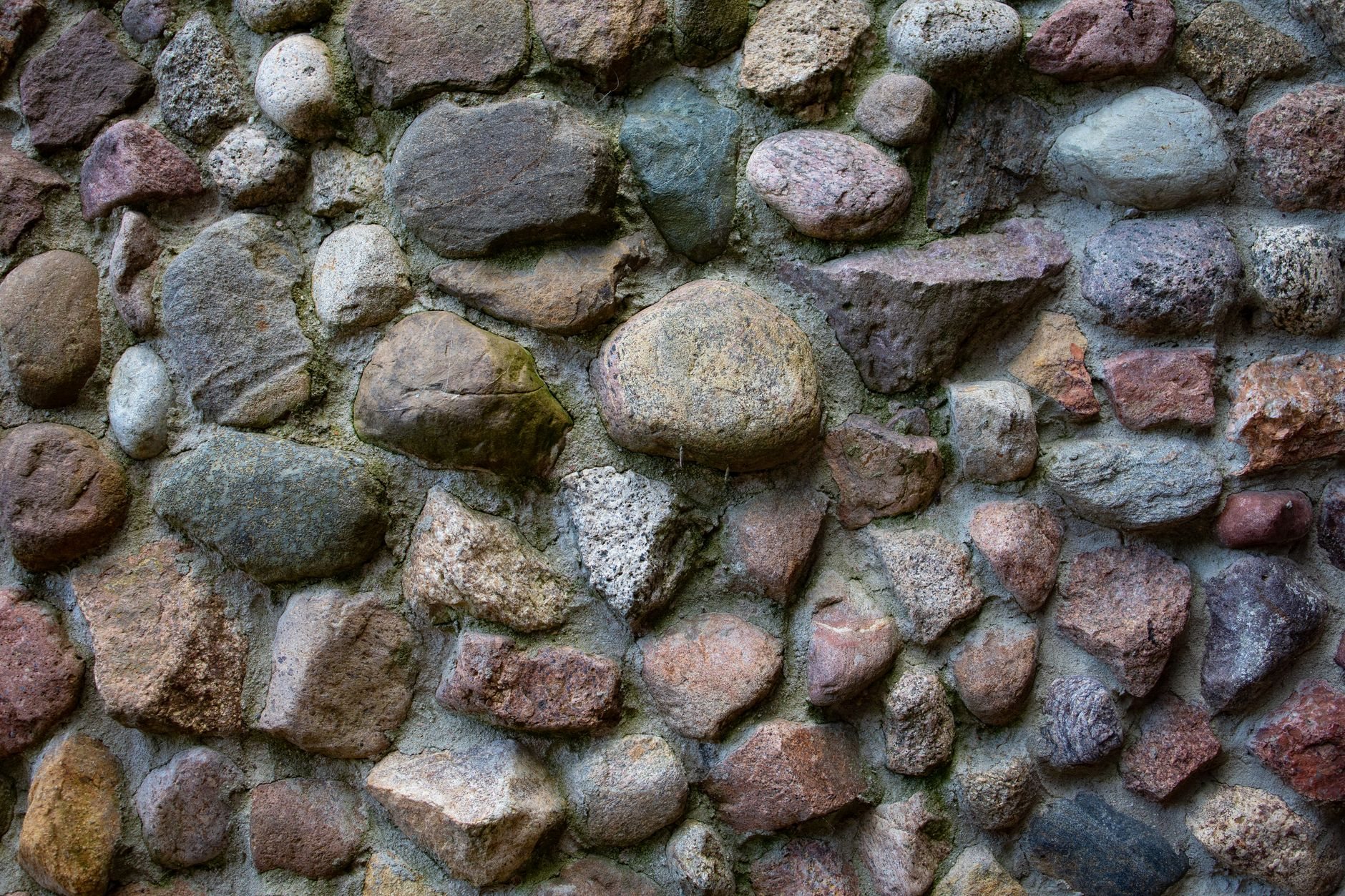 Close-up of a hand-laid stone wall with varied stone shapes and tight joints