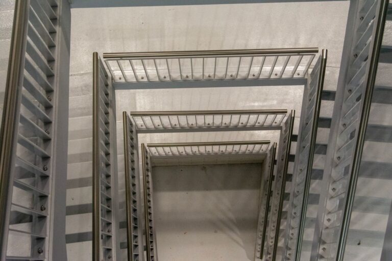 Stairs and railing: top view of a modern spiral staircase with metal balustrades and rails