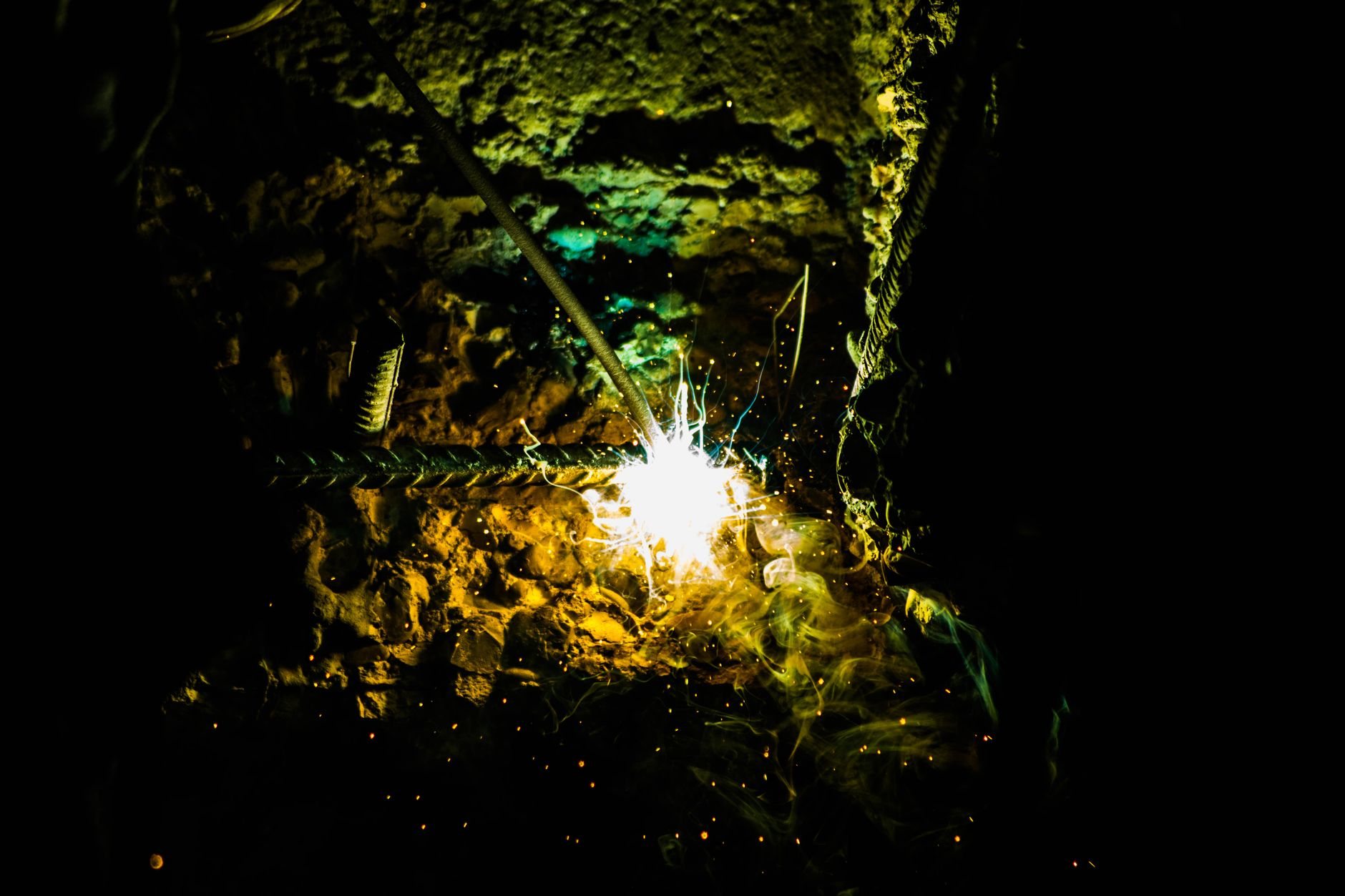 Field welding on structural steel at an active Utah construction site after dark