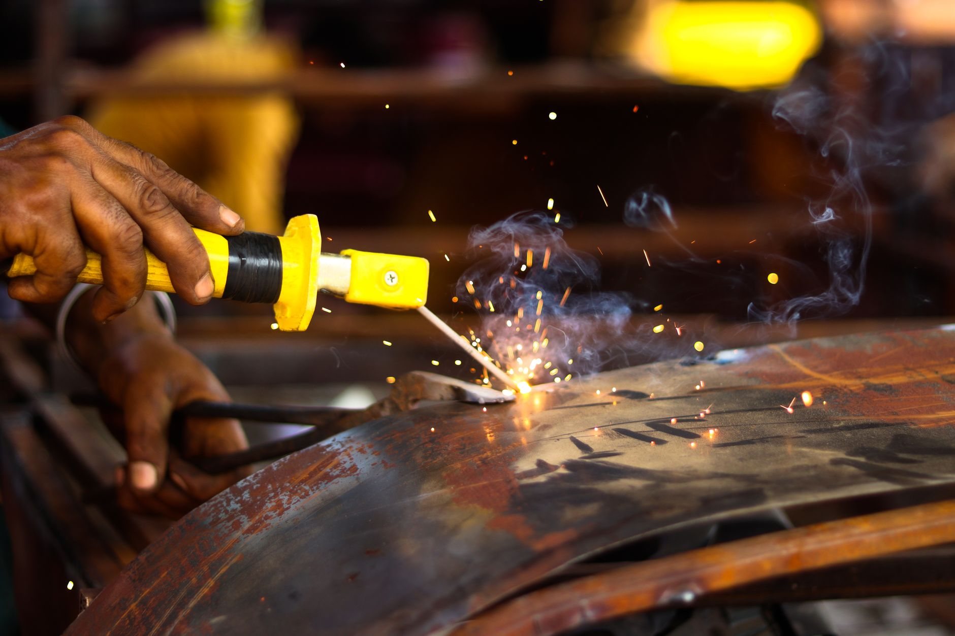 Welder fabricating structural steel components for a mezzanine frame