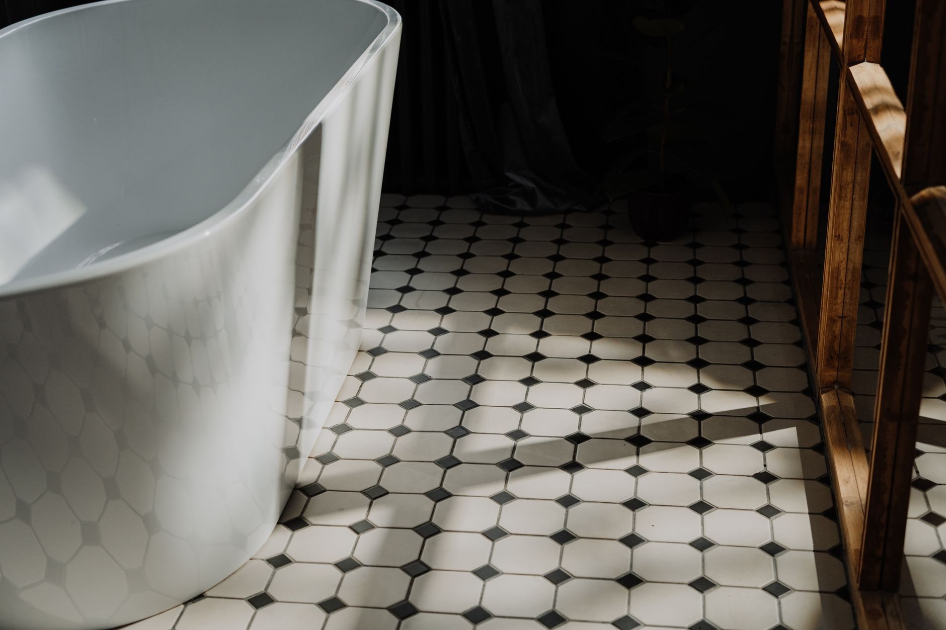 Finished bathroom with a freestanding tub and hexagonal floor tile