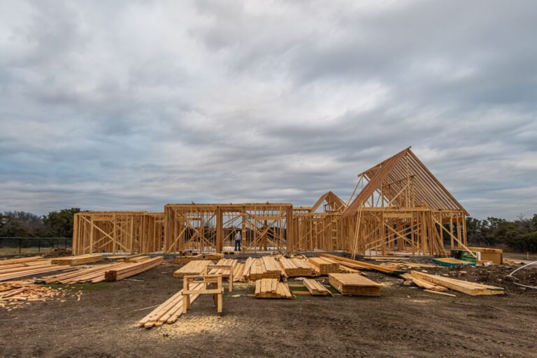Framing work on wooden house framing under construction in fort worth, tx during a cloudy day
