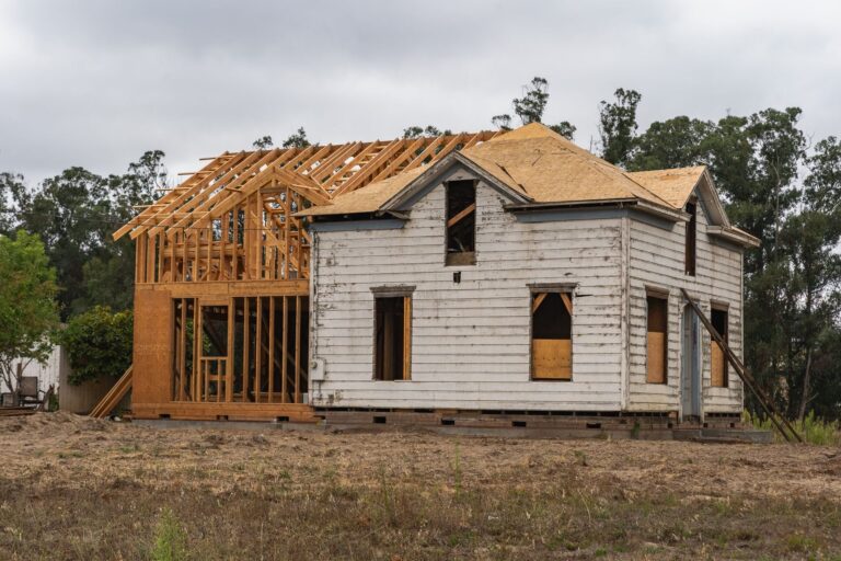 Framing work on image of an old house under renovation with new wooden frame structure